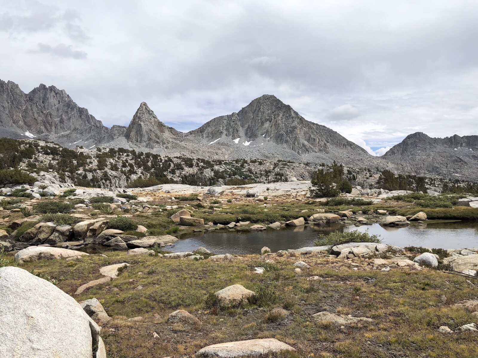 Alpine lake surrounded by mountains with reflective water surface