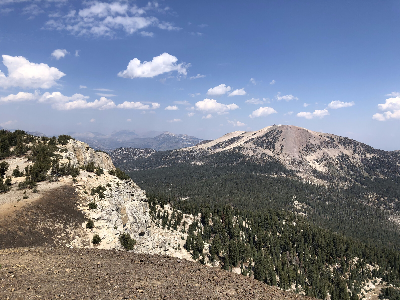 Forested peak with granite slopes and alpine meadow