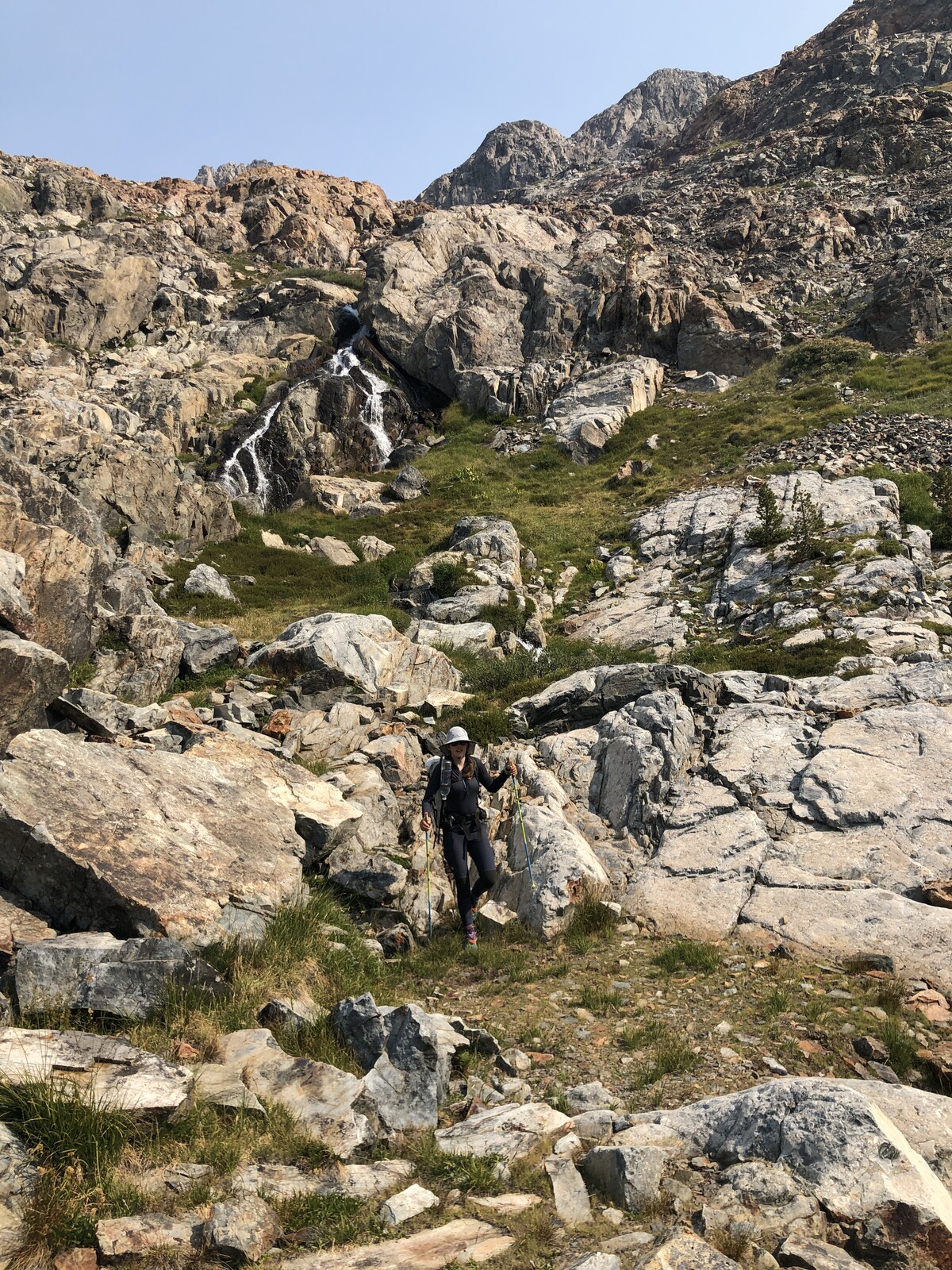 Rocky alpine trail winding through boulder-strewn terrain