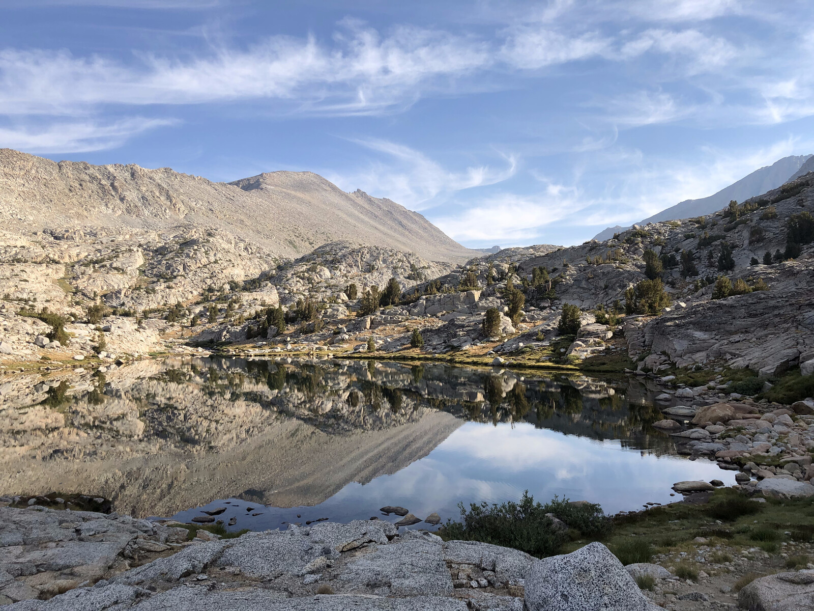 Mirror reflection of mountains in pristine alpine lake