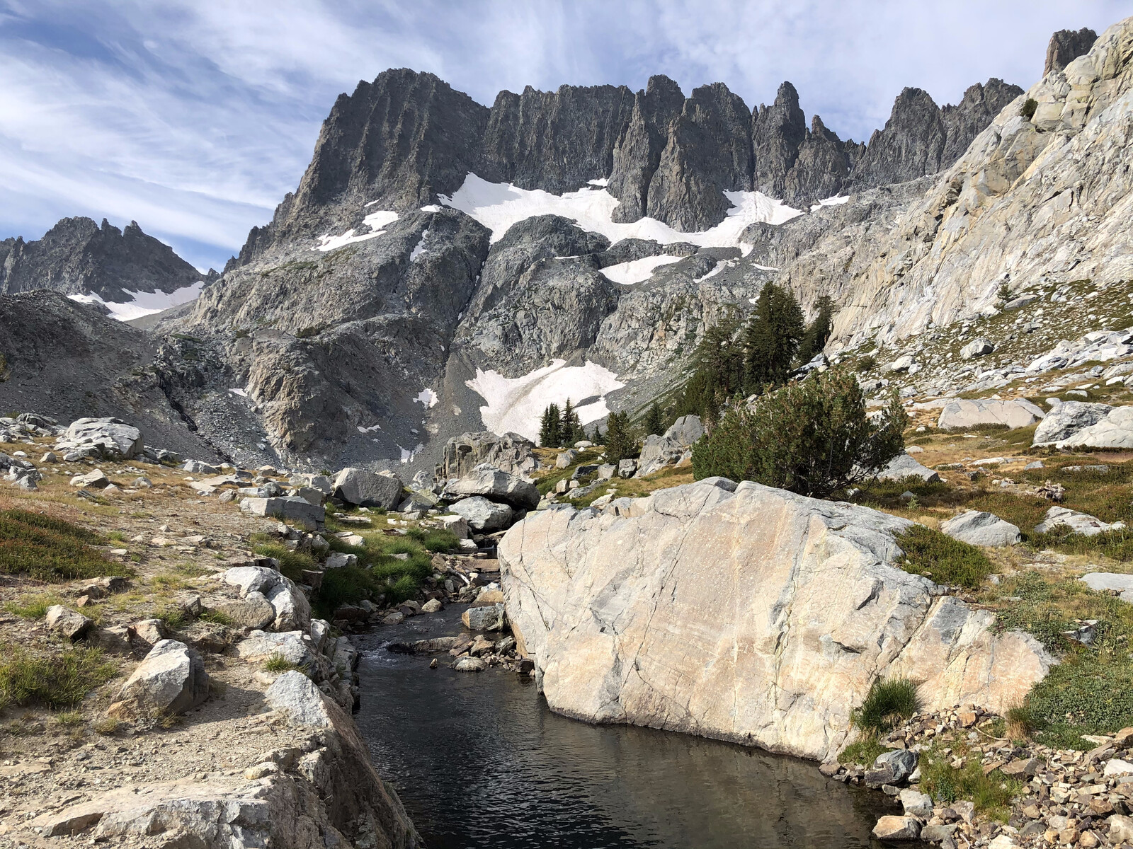 Alpine stream flowing through rocky glaciated basin